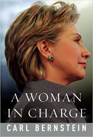 Book cover depicting a right-facing profile portrait of Hillary Rodham Clinton. Her blond hair is cut short and brushed back from her face as she looks sternly ahead, and is wearing a gray blazer and earrings. White text along the bottom shows the title and author: "A Woman in Charge" by Carl Bernstein.